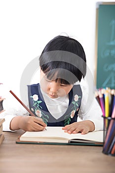 Cute Chinese little girl studying