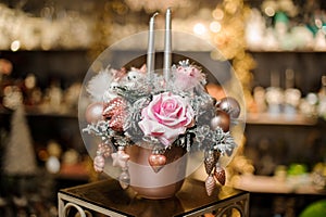 Cute christmas flower arrangement with flower and silver shiny Christmas tree toys with sparkles