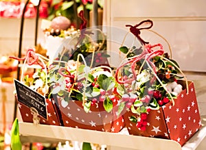 Cute Christmas presents in a florist shop. Boxes with decoration, presents and flowers being sold for Christmas