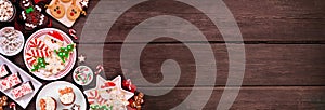 Cute Christmas sweets and cookie corner border on a rustic dark wood banner background