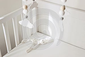 Cute cloud mobile hanging on crib in nursery room