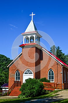 Country Brick Church with White Cross Steeple