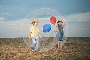 Cute couple with balloons. Adorable kids having fun. While having fun outdoors. Emotions on the face. Close friends