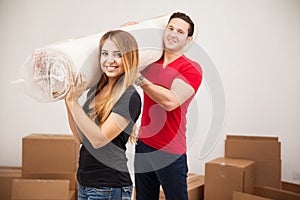 Cute couple carrying a rug