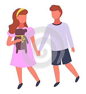 Cute couple of children, little girl wearing pin dress with teddy bear holding hands with boy