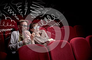 Cute couple in cinema watching movie