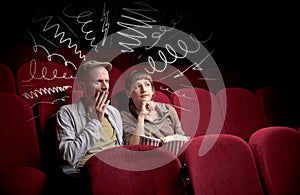 Cute couple in cinema watching movie