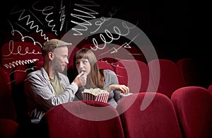 Cute couple in cinema watching movie