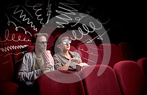 Cute couple in cinema watching movie
