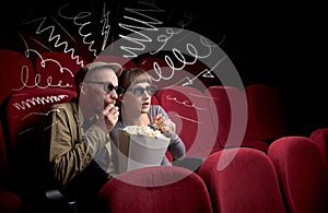 Cute couple in cinema watching movie