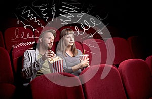 Cute couple in cinema watching movie