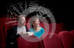 Cute couple in cinema watching movie