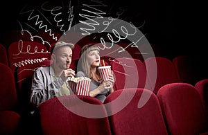 Cute couple in cinema watching movie