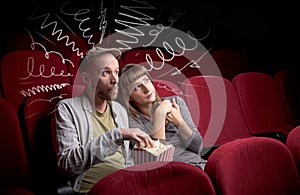 Cute couple in cinema watching movie