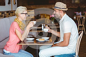 Cute couple on a date talking over a cup of coffee