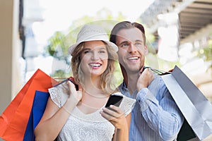 Cute couple holding shopping bags