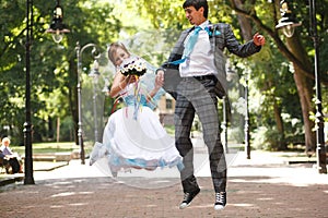 Cute couple jumping and smiling on background park