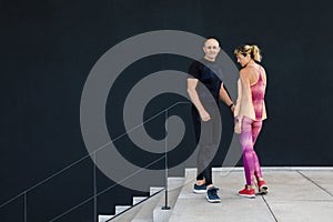 Cute couple - man and woman, actively spend time in the open air, preparing for training. . Healthy Lifestyle