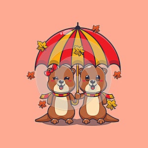 Cute couple otter with umbrella at autumn season.