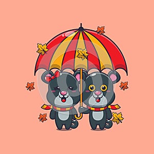 Cute couple panther with umbrella at autumn season.