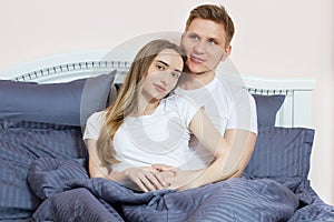 Cute couple relaxing on bed and hugging , love and relationships concept