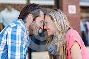 Cute couple sitting at a cafe head to head