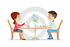 Cute couple sitting at table, drinking tea or coffee and talking. Young funny man and woman at cafe on date. Dialog or