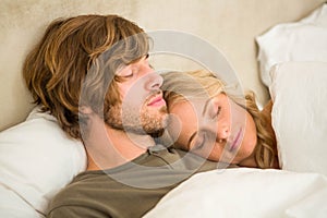 Cute couple sleeping on their bed