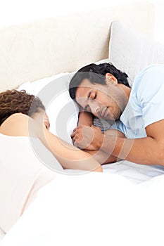 Cute couple sleeping together in their bed