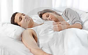 Cute couple sleeping together on their bed