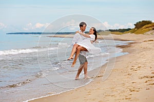 Cute couple of sweethearts have fun on the sea coast