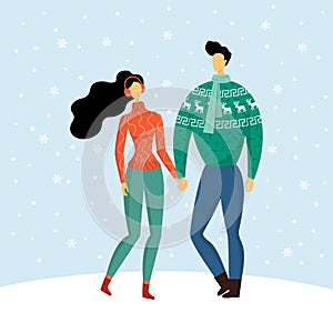 Cute couple in warm cozy sweaters holding hands, enjoying the love and snowy winter. Man and woman welcome Christmas and New year