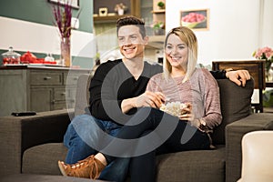 Cute couple watching a comedy on TV