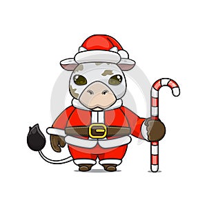 cute cow â€‹â€‹wearing santa costume holding candy cane for christmas