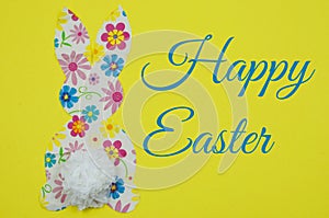 Cute, craft cut-out Easter bunny shape made out of cheerful patterned and colorful paper napkins and a tissue paper tail on a