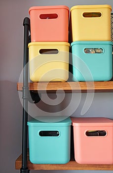 Cute creative design of green orange and yellow plastic container on the bedroom shelf for storage