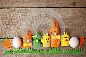 Cute creative photo with easter eggs, papaer cratf diy chiken and the Easter Bunny, holiday springtime concept, copy space
