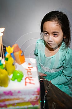 Cute crying little  girl celebrating birthday. Child unhappy for no reason indoor