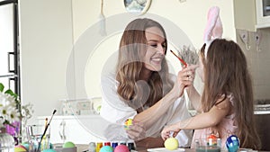 Cute daughter with mommy preparing for easter and play with each other