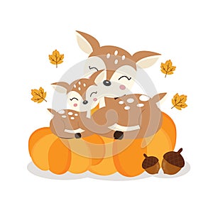 Cute deer mom and baby on pumkins in autumn.