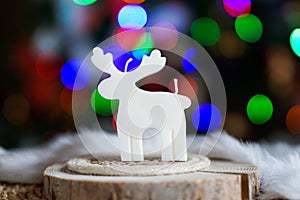 Cute deer shaped soy wax candle, Christmas lights in the background