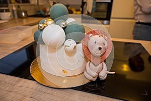 Cute and delicious cake with small lion next to it.