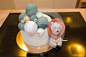 Cute and delicious cake with small lion next to it.