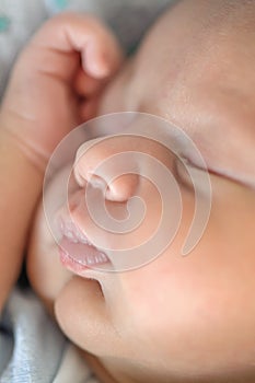 Cute detail macro portrait view of peaceful baby head face