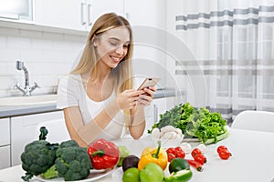 Cute Dieting Girl Using Smartphone to Check Caloricity photo