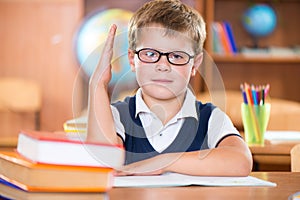 Cute dilligent schoolboy in glasses