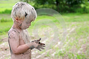 Cute Dirty Child Playing Outside in the Country