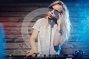 Cute dj woman having fun playing music at club party