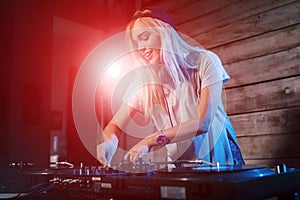 Cute dj woman having fun playing music at club party