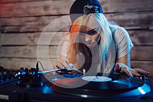 Cute dj woman having fun playing music at club party